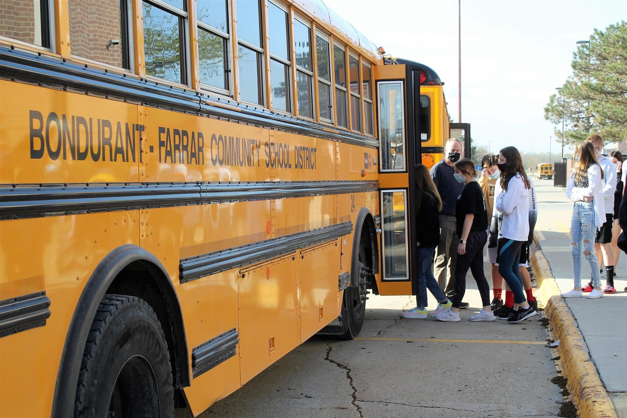 Middle school students boarding a bus in preparation for evacuation drills